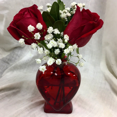 Red rose in heart vase
