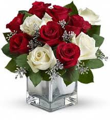 red and white roses in block vase